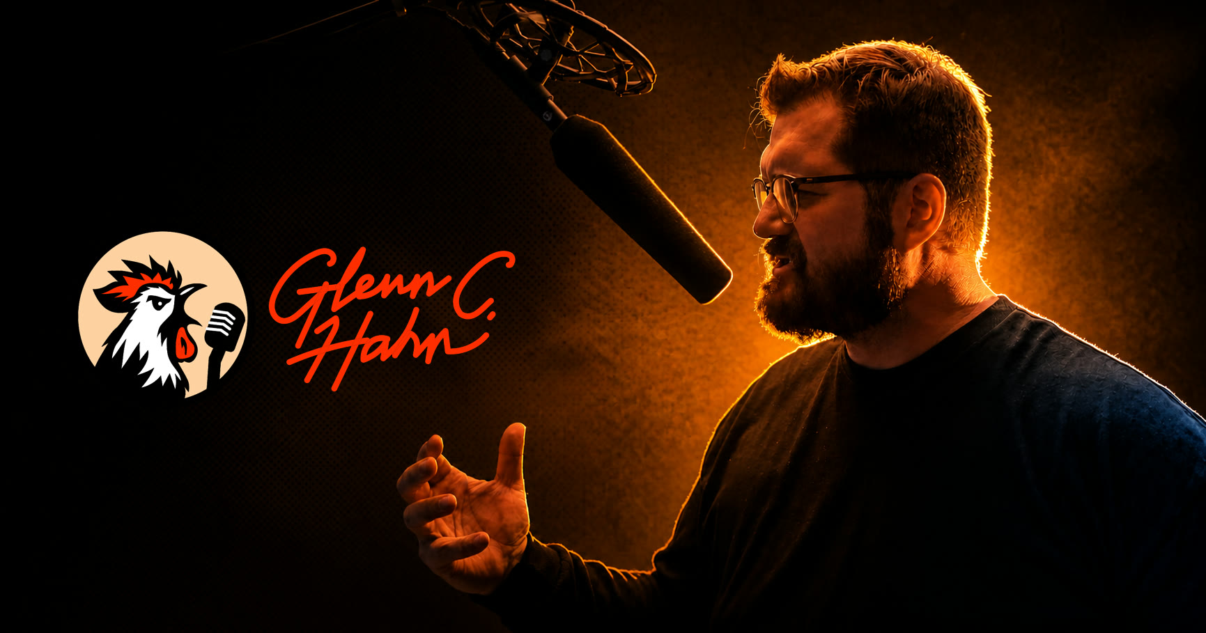 Glenn C. Hahn performing beneath a studio microphone beside his rooster-and-microphone identity mark